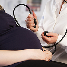 Pregnant woman having blood pressure check 222