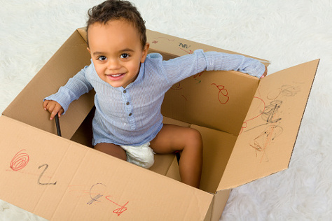 Toddler in a cardboard box