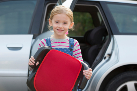 Child holding booster car seat