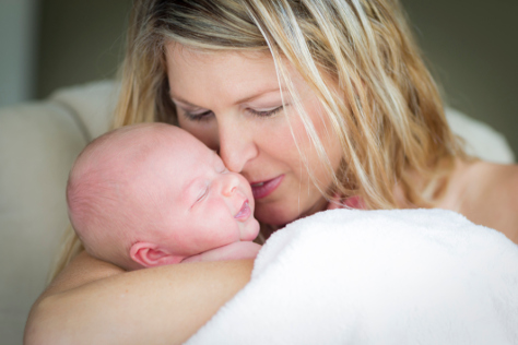 Mum cuddling newborn