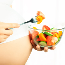 Pregnant woman with salad bowl