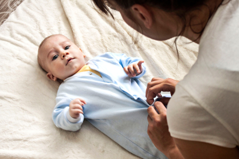 Mum dressing newborn