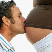 Man kissing pregnant belly