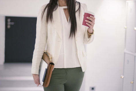 Woman walking into office with coffee