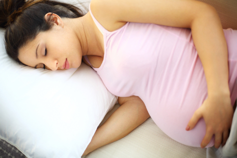 Pregnant woman asleep on her side