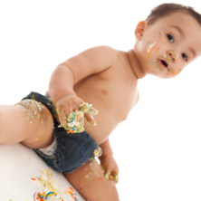 Baby covered in cake