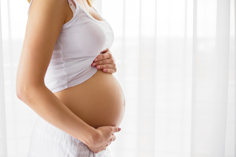 Pregnant woman holding bump