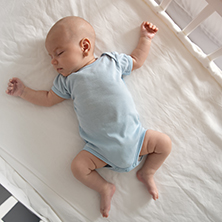 Baby asleep in cot 222