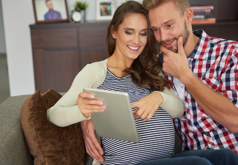 Pregnant couple on sofa