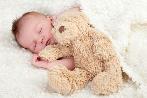 Baby asleep with teddy bear