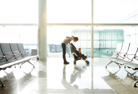 Mum with baby in buggy at airport 